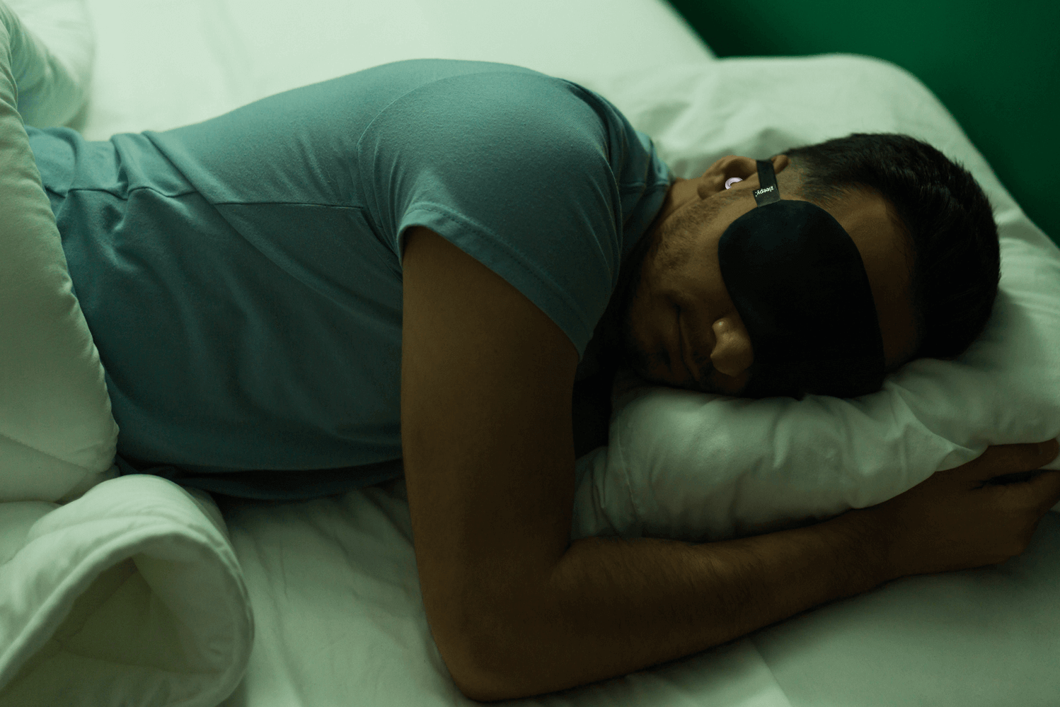 man-sleeping-with-earplugs-for-deep-sleep
