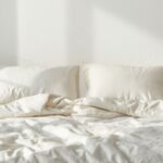 Neatly made bed with soft breathable cooling bedding