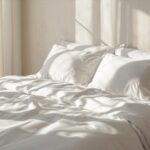 Fresh white bed linen in a bright minimal bedroom