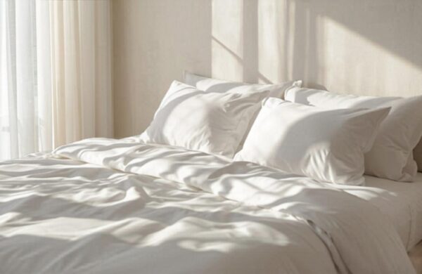 Fresh white bed linen in a bright minimal bedroom