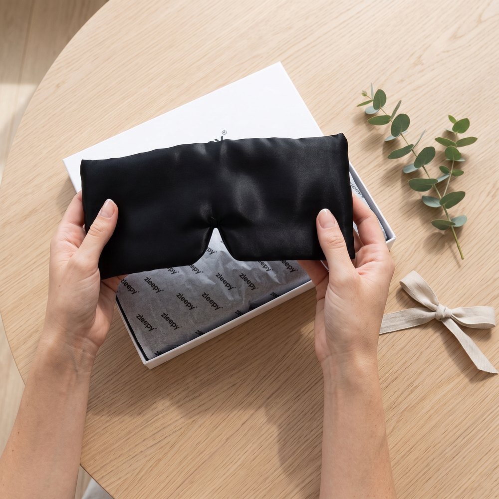 The Wrap Silk Sleep Mask being unboxed from its gift box